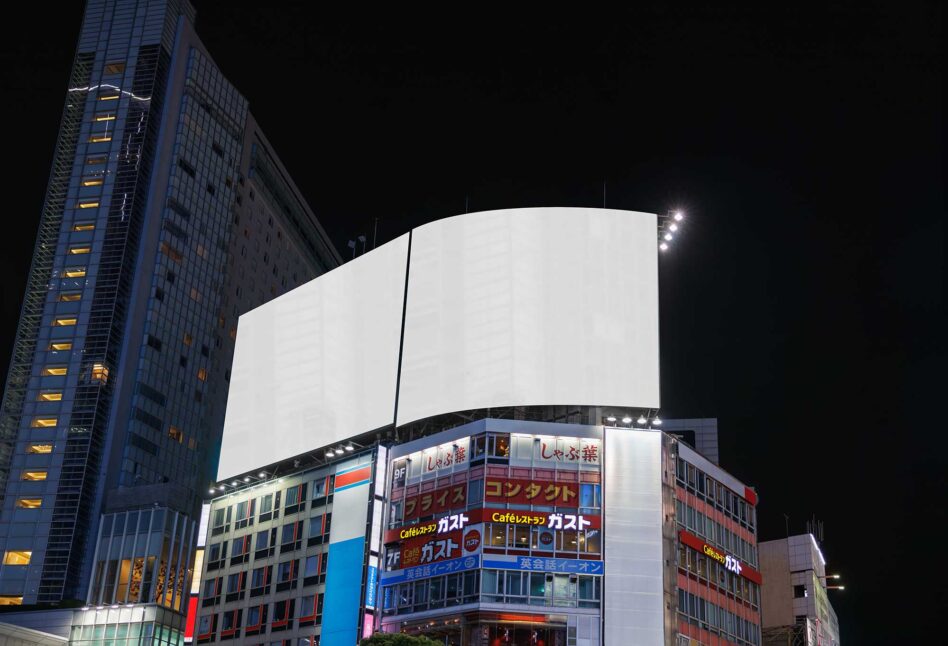 Night shot of curved billboard mockup glowing above Tokyo street with tall buildings, blank canvas