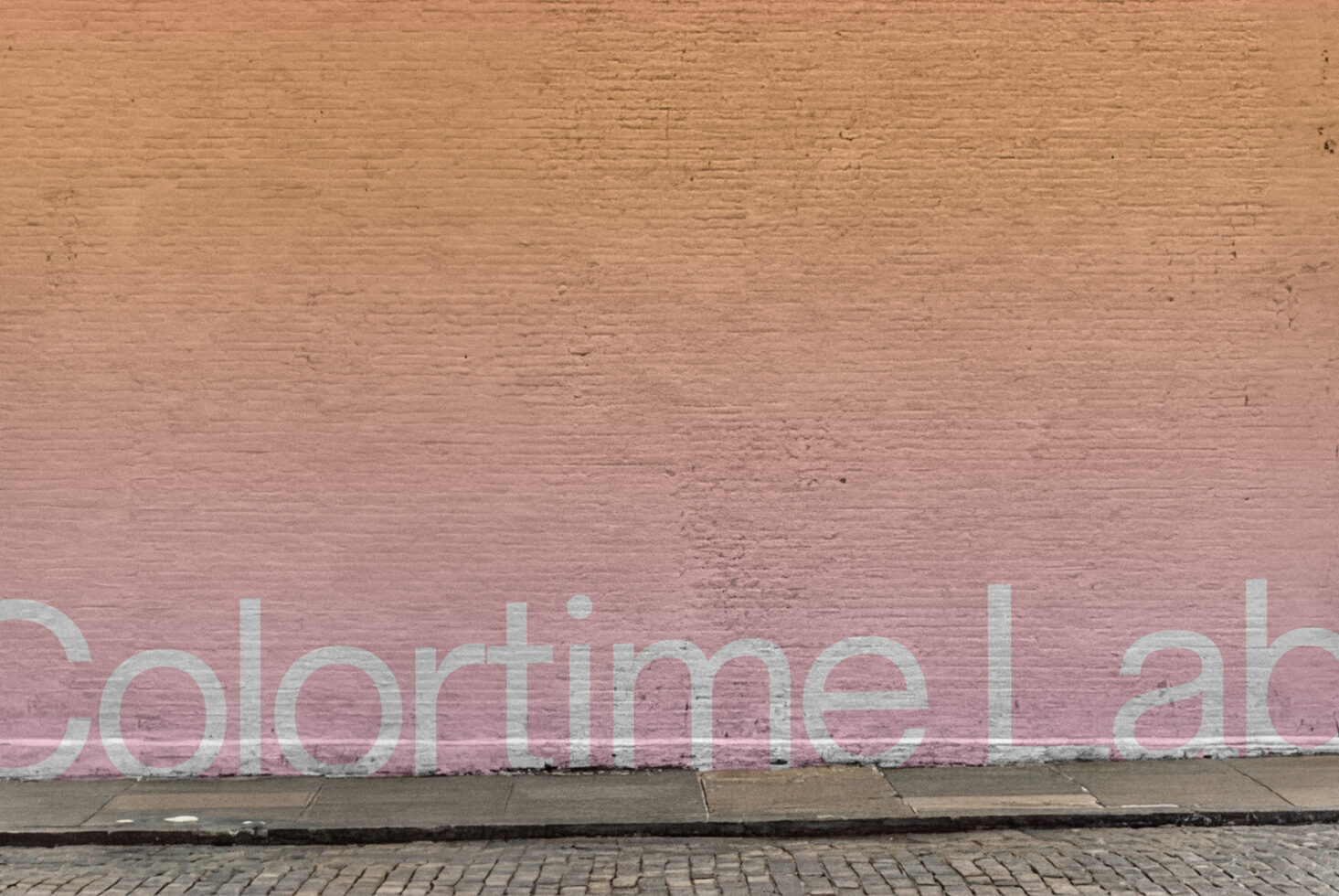 Gradient brick wall fading from tan to dusty rose with white text overlay