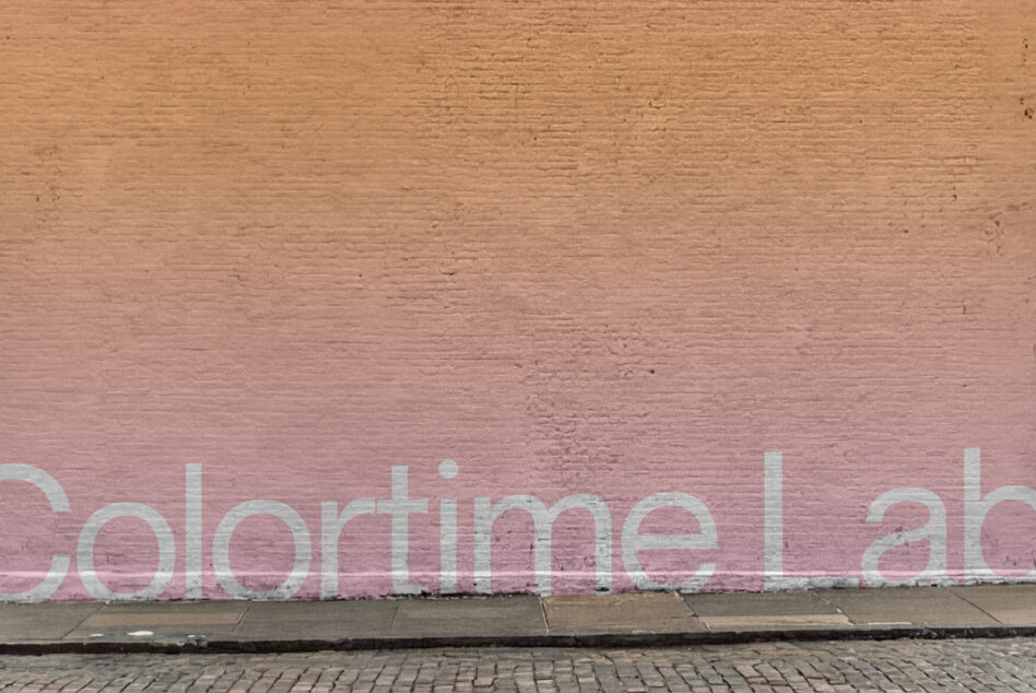 Gradient brick wall fading from tan to dusty rose with white text overlay