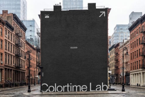 Dark brick building facade billboard mockup in urban courtyard setting with Colortime Lab text