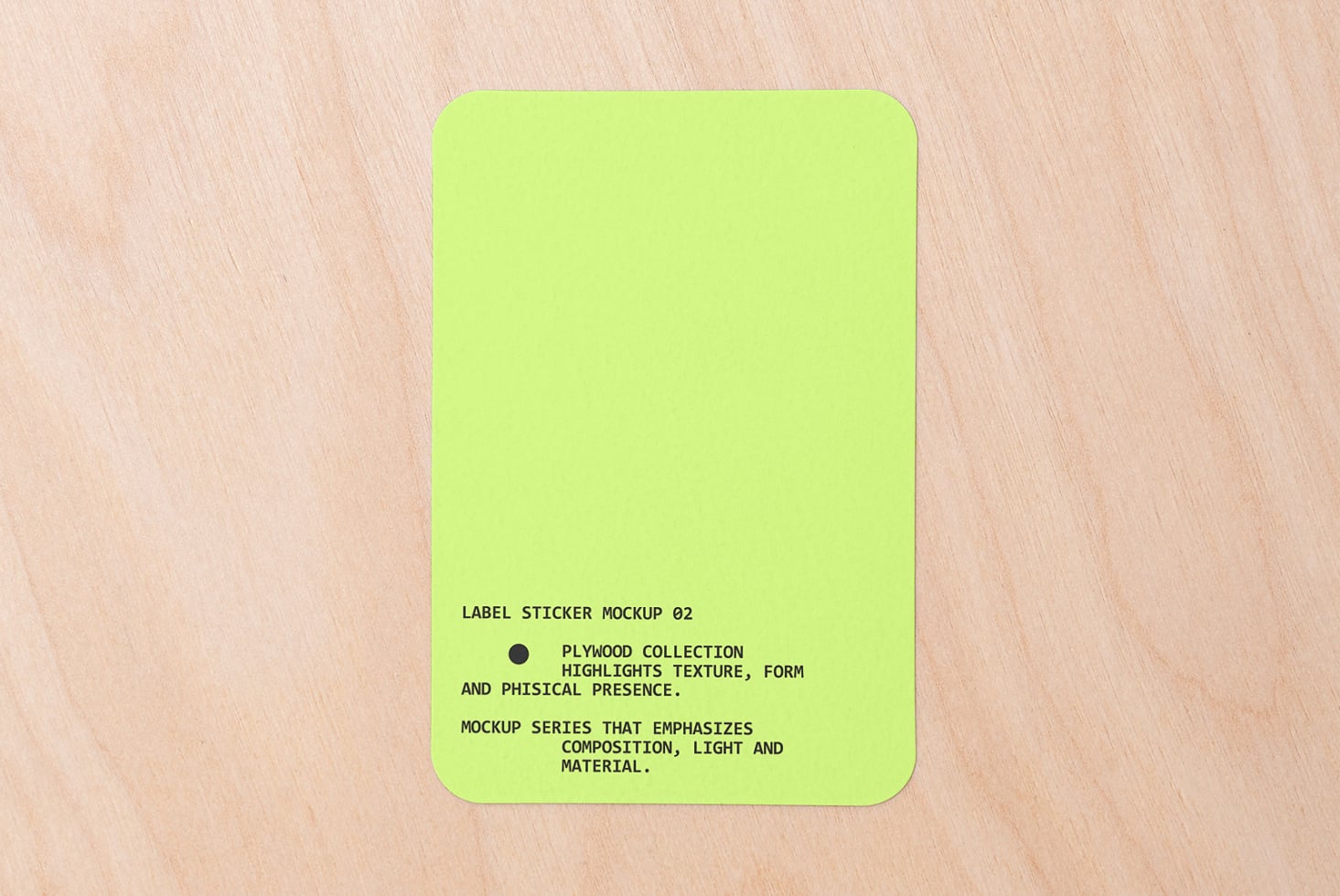 Neon yellow rounded square sticker on light wood with text centered bottom