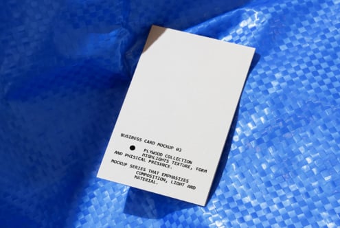 White business card mockup on blue textured background