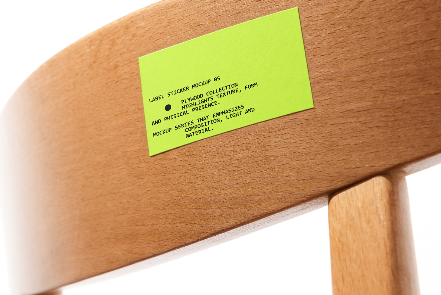 Lime green label sticker mockup on wooden chair rail closeup