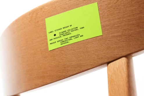 Lime green label sticker mockup on wooden chair rail closeup