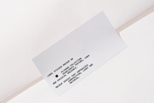 White label sticker on white background with black text copy angled view