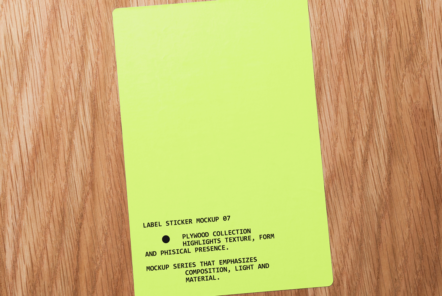 Bright lime green label sticker on wooden table with black text angled shot