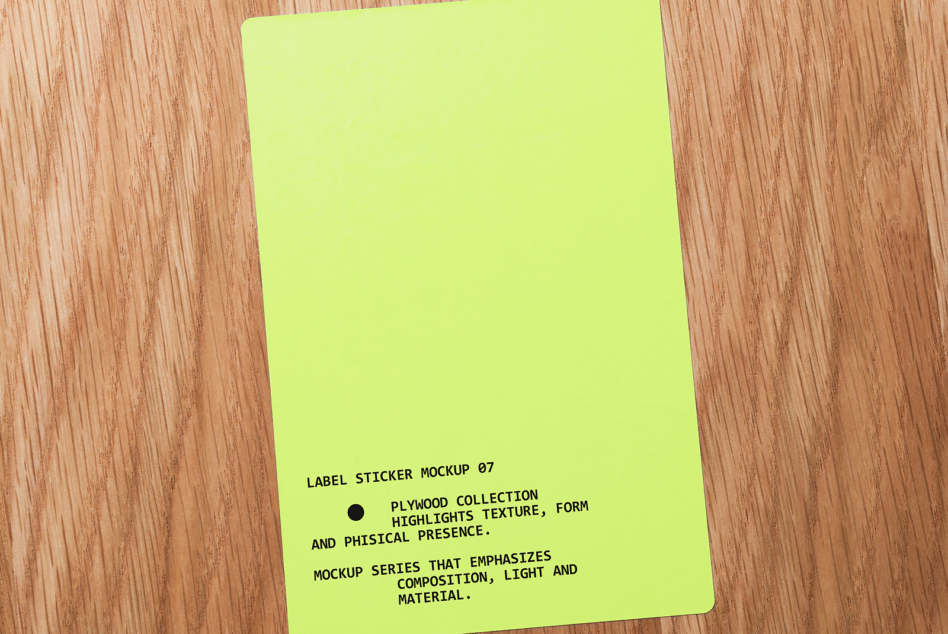 Bright lime green label sticker on wooden table with black text angled shot