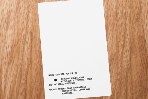 White label sticker on wooden table with black text angled shot overhead