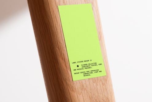 Large neon green sticker on natural wood pole with natural lighting