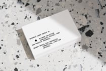 Stacked white business cards on terrazzo background with shadow detail