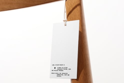White rectangular hang tag hanging from twine on wooden rack