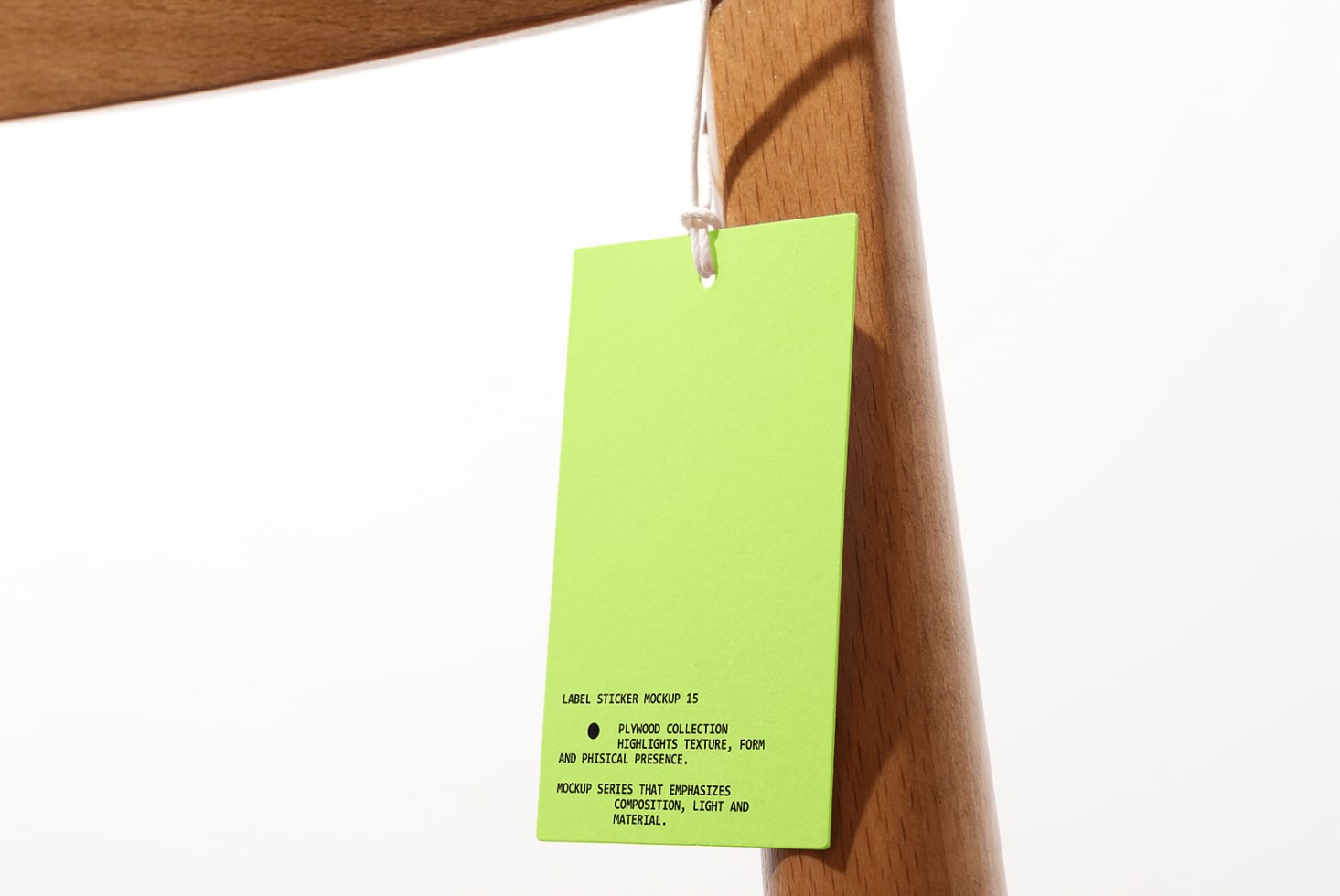 Neon yellow hang tag swinging from natural wood coat hanger