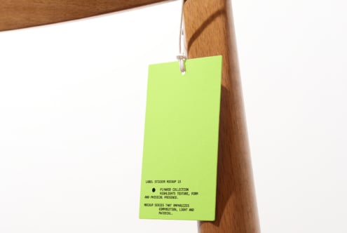 Neon yellow hang tag swinging from natural wood coat hanger