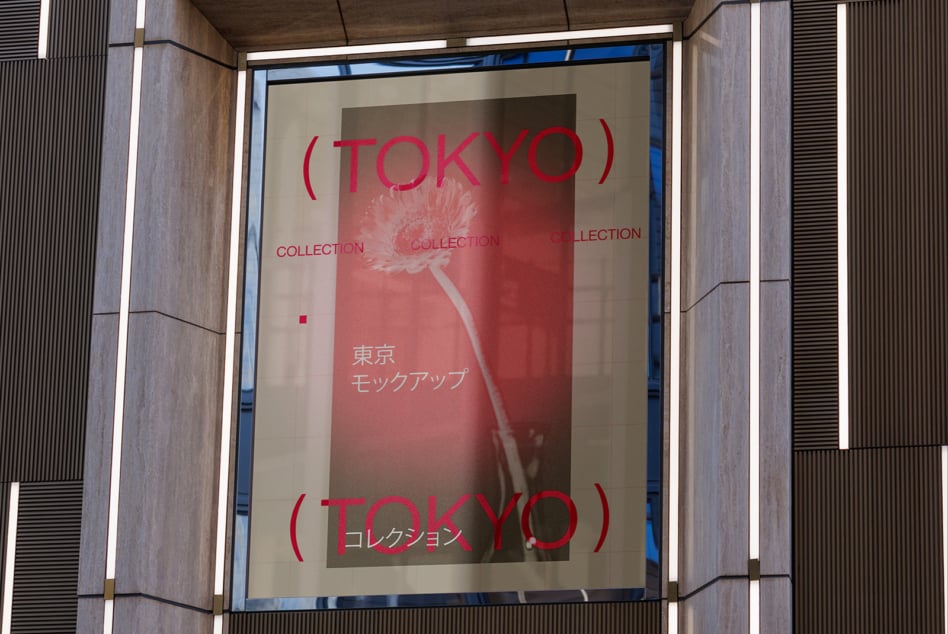 Red Tokyo Collection poster displayed in concrete storefront window with flower graphic centered