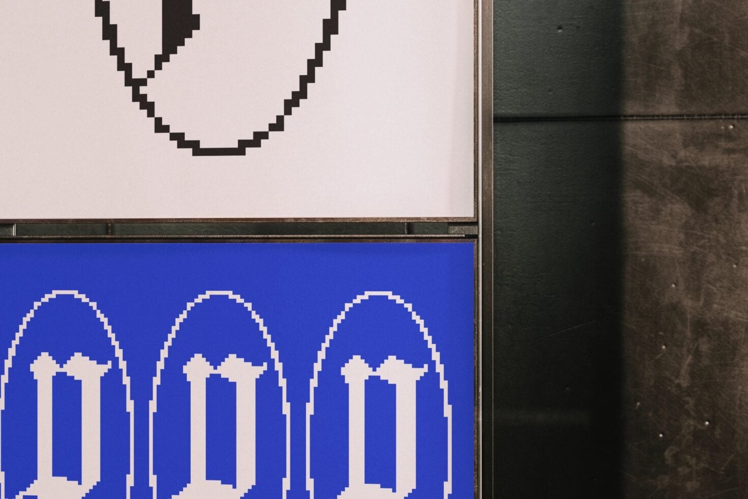 Split screen showing pixelated smiley on cream above arch logos on blue background