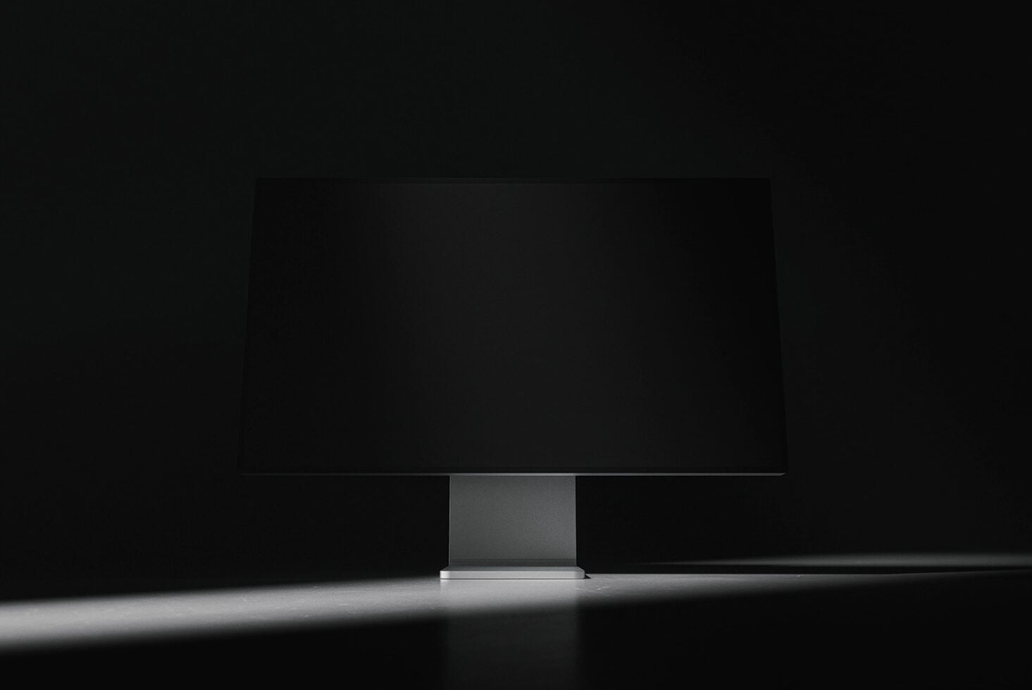 Dark minimalist monitor mockup centered on desk against black background