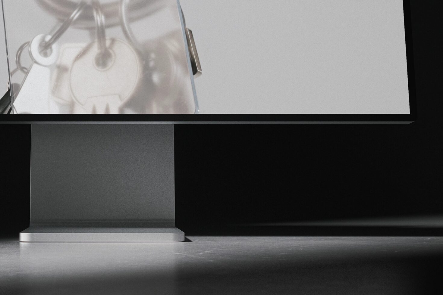 Minimalist workspace with monitor displaying hanging lamp gear silhouettes