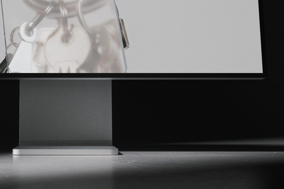 Minimalist workspace with monitor displaying hanging lamp gear silhouettes