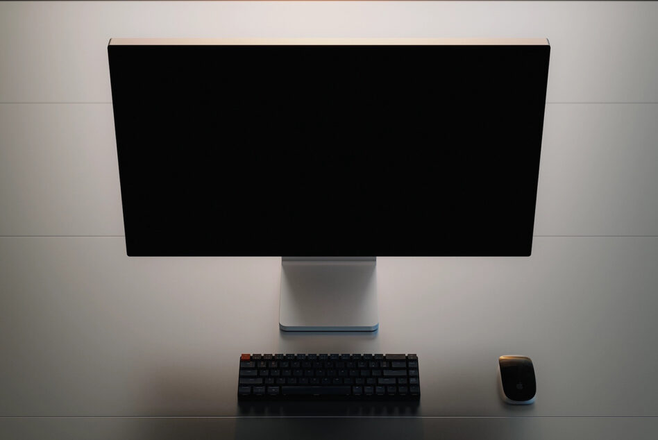 Monitor displaying product image with text overlay on desk setup
