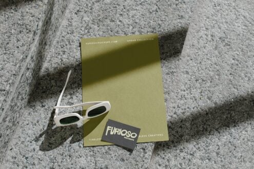 Olive stationery set with white frames casting shadows on concrete steps