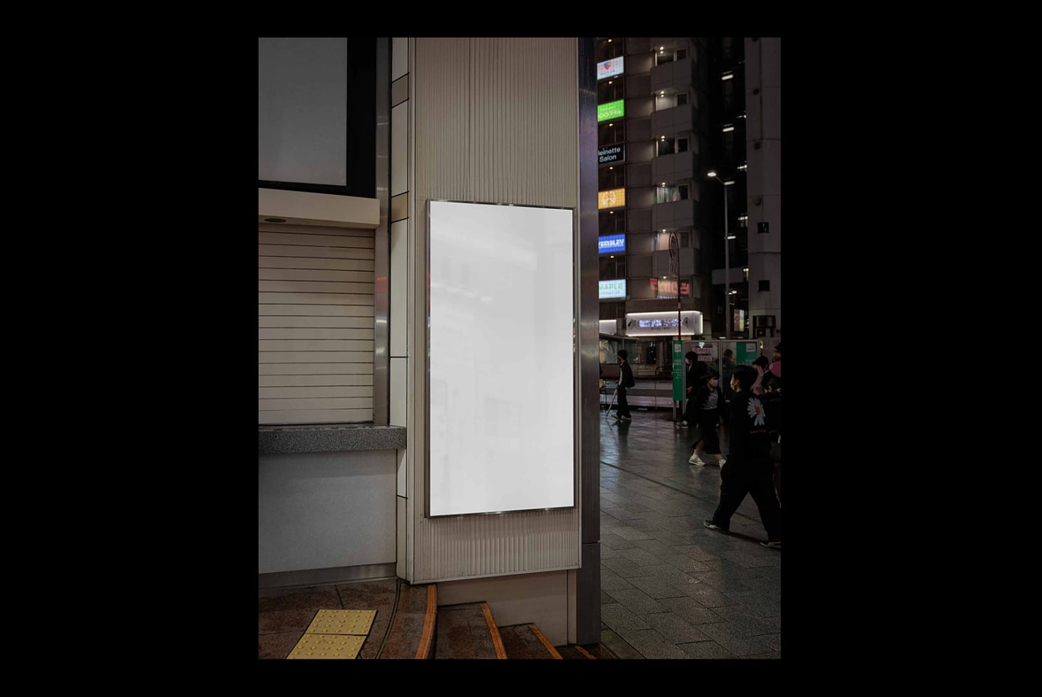 Blank vertical poster on urban street column with storefronts visible behind