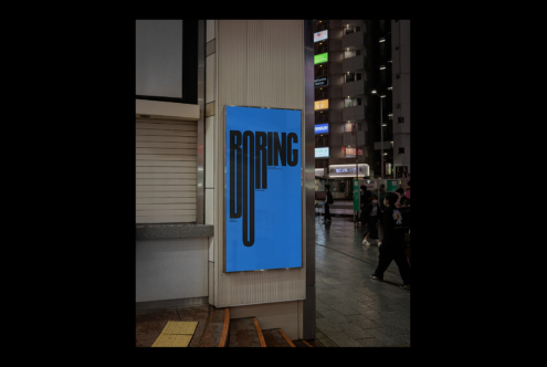 Blue poster with BORING text in bold letters on street column display