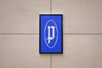 Framed display with pixelated cross symbol in white on deep blue