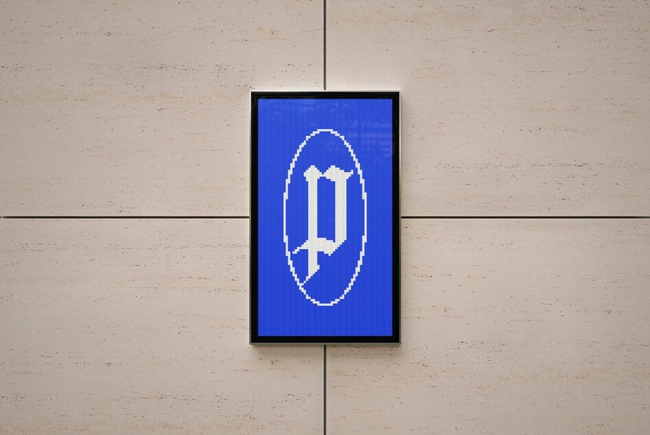 Framed display with pixelated cross symbol in white on deep blue