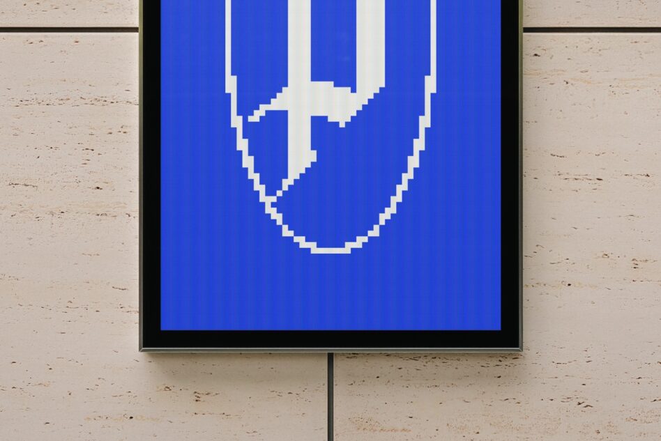 Framed screen showing pixelated smiley face on bright blue background