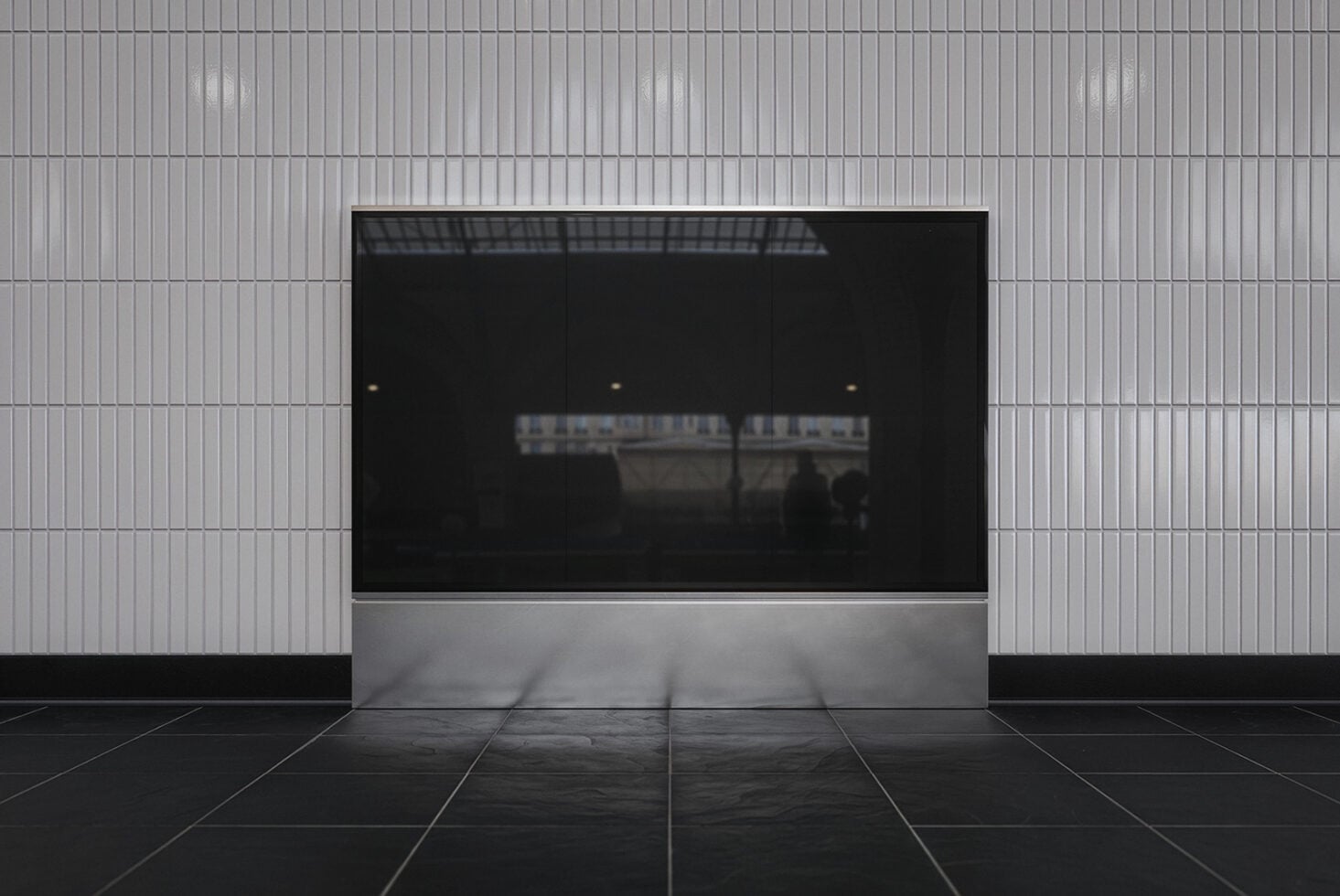 Storefront mockup with blank black screen surrounded by corrugated metal wall