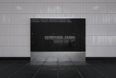 Storefront mockup with blank black screen surrounded by corrugated metal wall