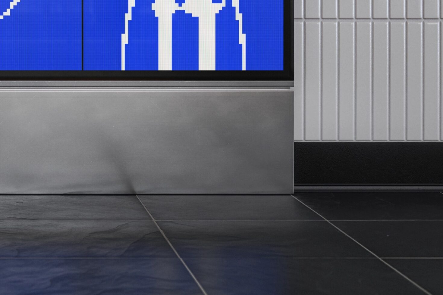 Indoor storefront mockup with blue pixelated pattern displayed on screen