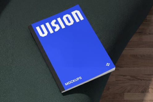 Bright blue hardcover book with white Illusion text on fabric material background