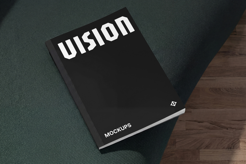 Black hardcover book with white Illusion text on top held against fabric texture