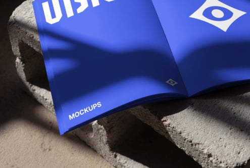 Open blue magazine spread with VISION text displayed on textured concrete background