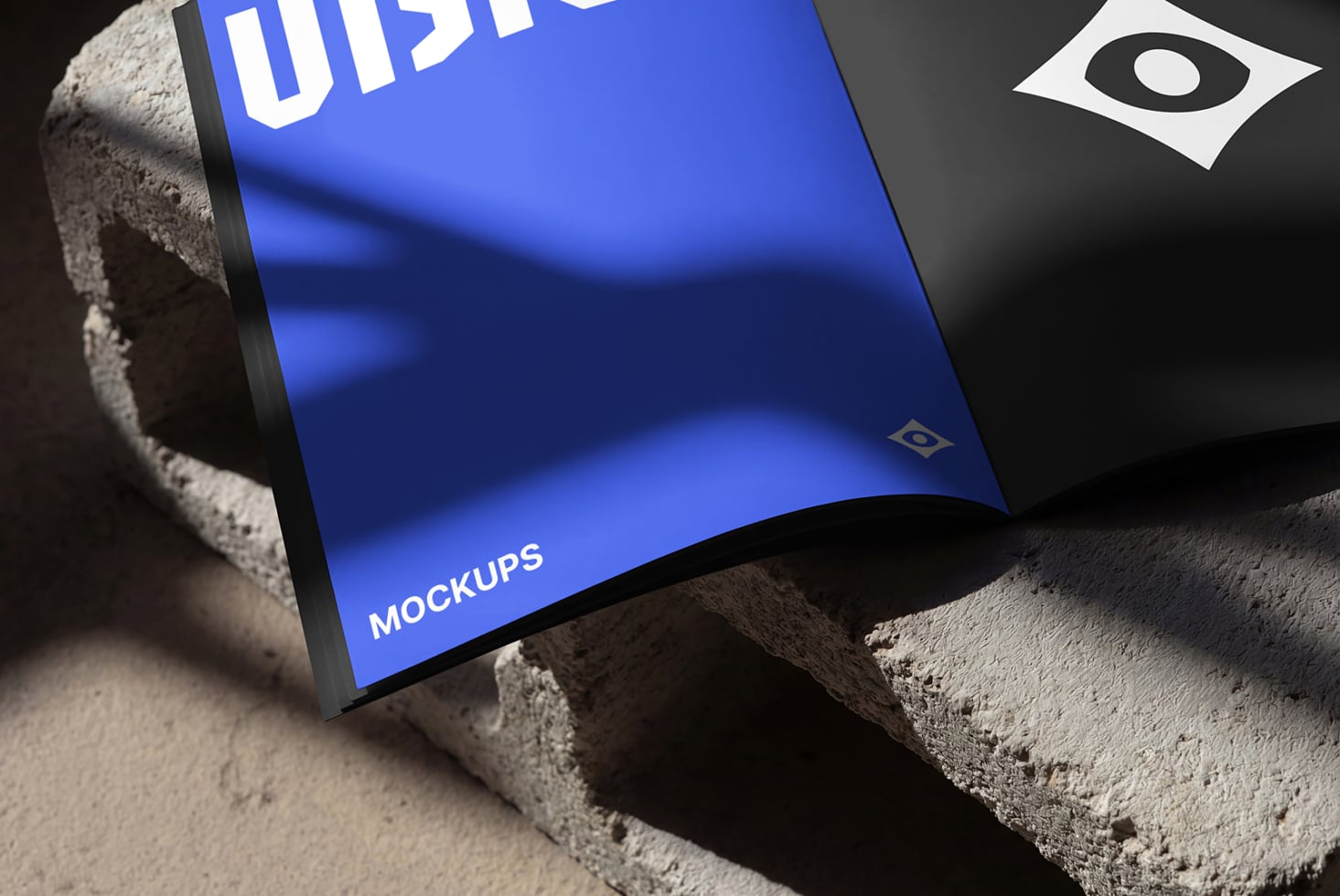 Blue curved magazine mockup with VISION text lying on rough concrete surface
