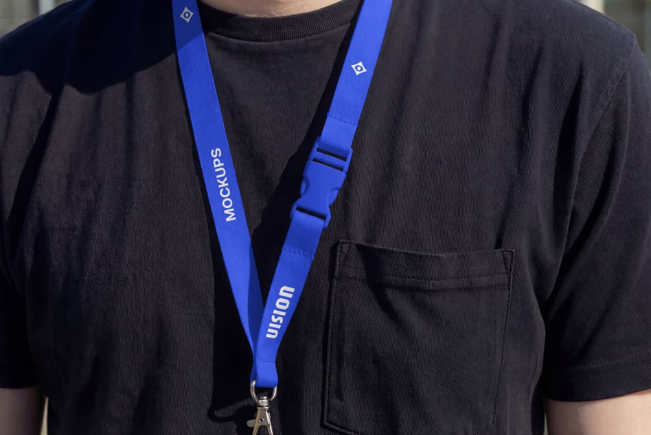 Bright blue lanyard worn over dark t-shirt with metal clip