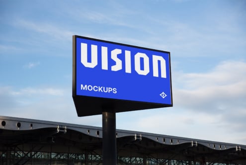 Roadside billboard with bright blue background displaying VISION text in white