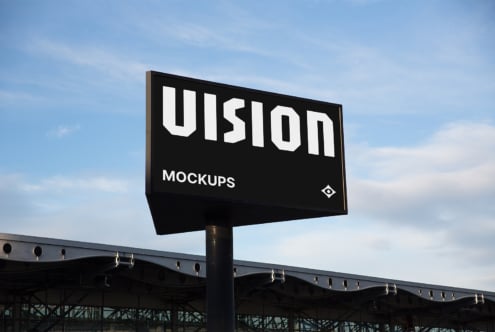 Street billboard sign with white VISION text on black background against sky