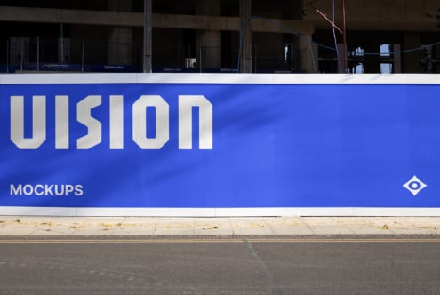 Bright blue building hoarding mockup featuring oversized UIsion lettering in white