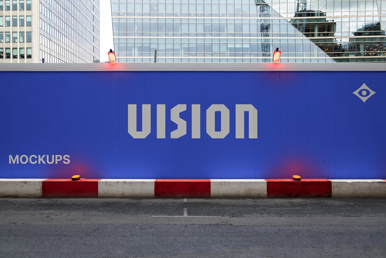 Blue construction hoarding displaying VISION branding with warning lights above
