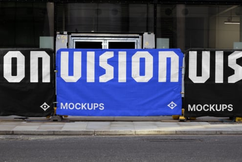 Blue hoarding billboard mockup with white sans-serif letters split between dark side panels