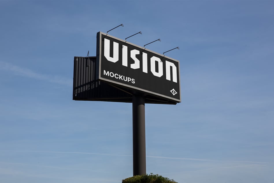 Large illuminated billboard featuring VISION text with lights on tall pole