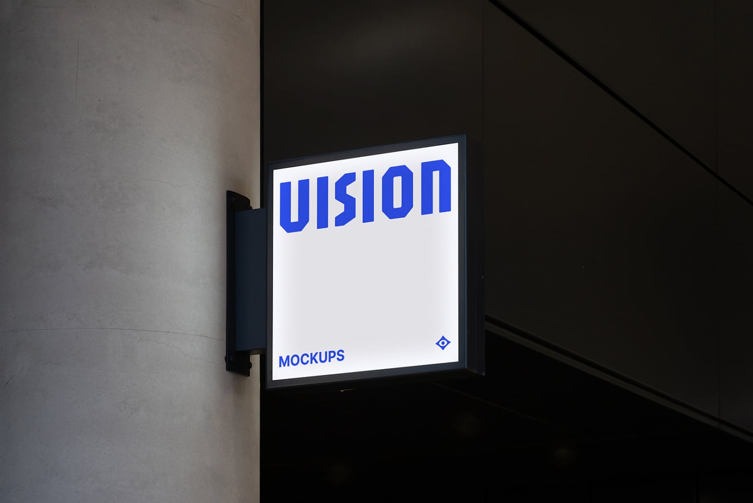 Illuminated storefront sign mounted on dark wall showing white VISION text on light background