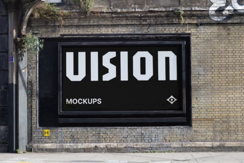 Black storefront display showing VISION text on brick building