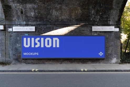 Bright blue billboard displaying VISION in white letters on brick