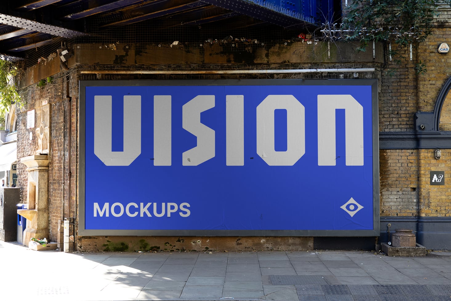 Bright blue billboard with oversized VISION text, worn brick warehouse backdrop