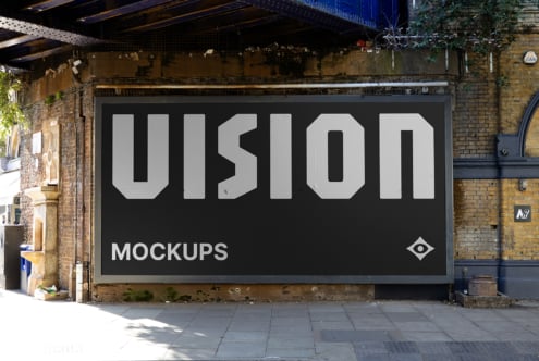 Oversized black storefront billboard with VISION text on industrial brick