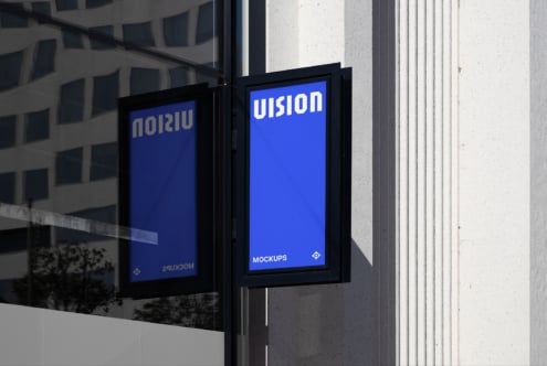 Lit storefront window display with double black frames bright blue mockup