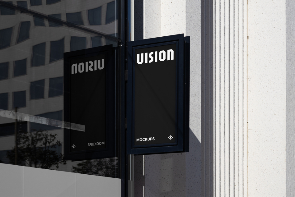 Dark storefront window with two black-framed signs showing white text mockup